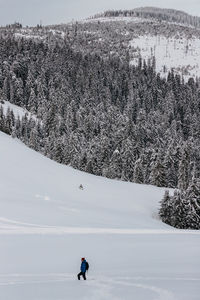 Man skiing on snow covered field