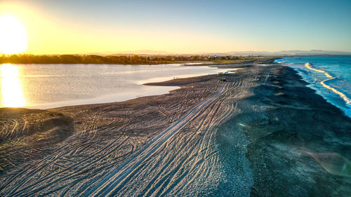 Scenic view of sea against clear sky during sunset