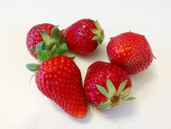 High angle view of strawberries on table against white background