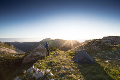 Man standing on mountains against sky