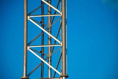 Low angle view of ladder against clear blue sky