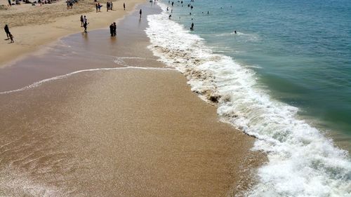People on beach against ocean background copy space