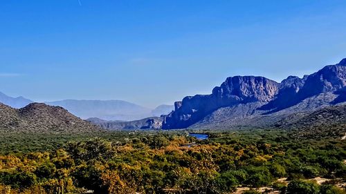 Scenic view of mountains against blue sky