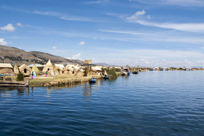 Panoramic view of sea and buildings against sky