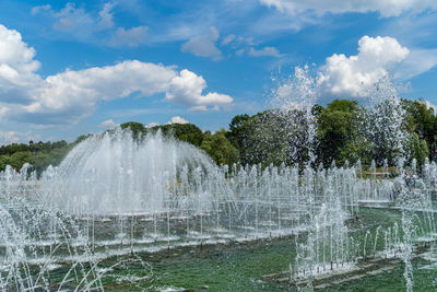 Water splashing in fountain against sky
