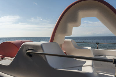 Pedal boat on sea against sky