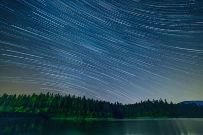 Scenic view of lake against sky at night