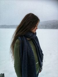 Close-up of young woman standing in snow