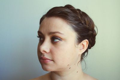 Close-up of beautiful young woman over white background