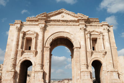 Low angle view of historical building against cloudy sky