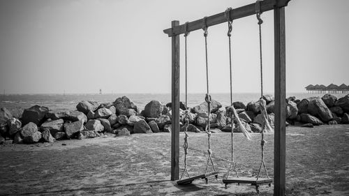 Panoramic view of rocks on beach against clear sky