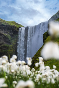 Scenic view of waterfall against sky
