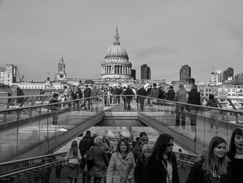 People in front of building against clear sky