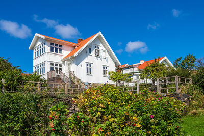 Low angle view of house and trees against sky