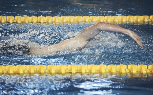 High angle view of young man swimming in pool