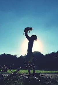 Silhouette of girl jumping in mid-air