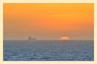 Scenic view of sea at sunset