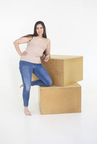 Portrait of smiling young woman against white background