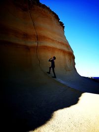 Rear view of man on rock