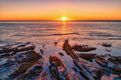 Scenic view of sea against sky at sunset
