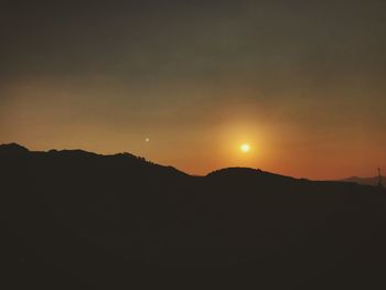 Scenic view of silhouette mountains against sky during sunset