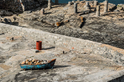 High angle view of abandoned boat on rock