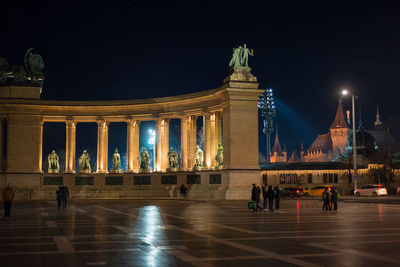 Group of people in front of building at night