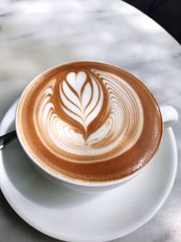 High angle view of cappuccino on table