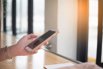 Midsection of man using mobile phone