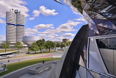 View of modern buildings against cloudy sky