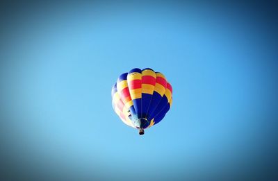 Low angle view of kite flying against clear blue sky