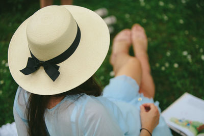 Rear view of woman holding hat