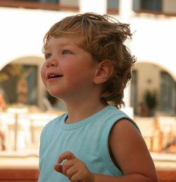 Close-up of happy boy looking up