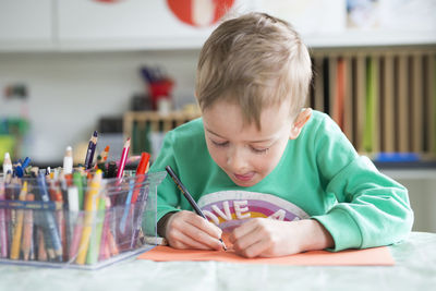 Boy drawing on paper