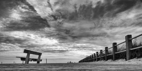 Scenic view of beach against cloudy sky