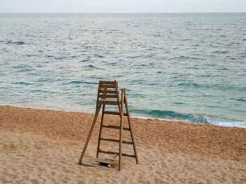 Lifeguard hut on beach against sky