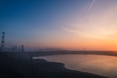Scenic view of lake against sky during sunset