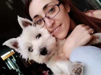 Portrait of smiling young woman with cat