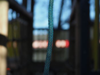 Close-up of chain hanging on metal fence