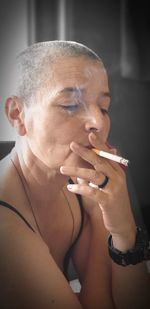 Bald woman smoking cigarette