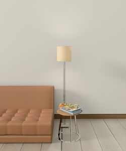 Electric lamp and stool by sofa at home