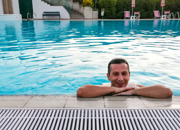 Portrait of shirtless boy swimming in pool