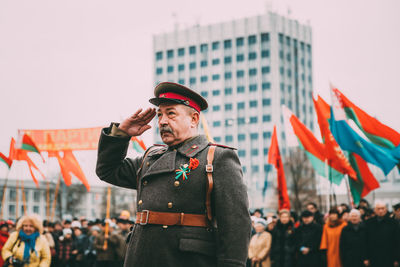 Midsection of man standing in city