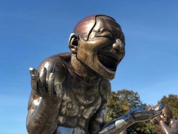 Low angle view of statue against clear blue sky