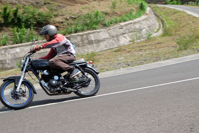 Man riding bicycle on road