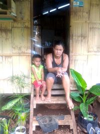 Full length of girl sitting outdoors