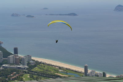 High angle view of parachuting over calm sea