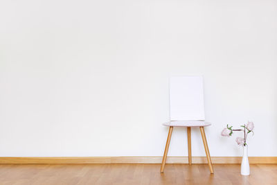 Table and chairs on hardwood floor against wall at home