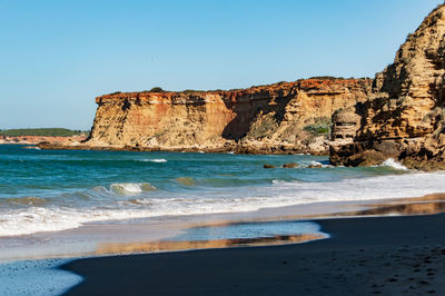 Scenic view of sea against clear blue sky