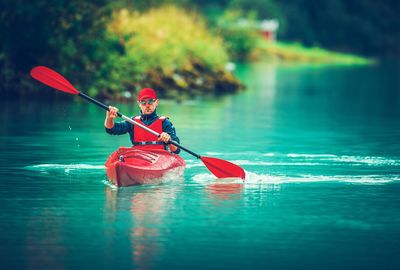 Man kayaking in lake